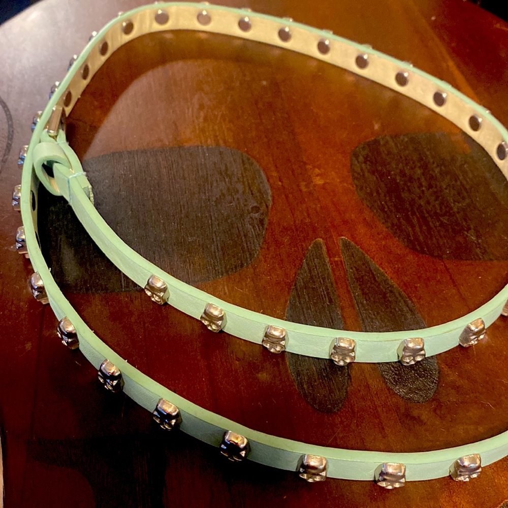 Silver skull studded teal belt. 45 inches long